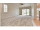 Large bedroom featuring neutral carpet, ceiling fan, and french doors leading to the outside at 11527 Morning Grove Dr, Las Vegas, NV 89135