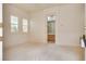 Neutral bedroom provides two shuttered windows, plush carpet and an ensuite bathroom at 11527 Morning Grove Dr, Las Vegas, NV 89135
