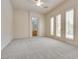 Large bedroom with plush carpet and doors leading to the outside at 11527 Morning Grove Dr, Las Vegas, NV 89135