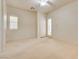 Bright bedroom features plush carpet, a ceiling fan, and a sliding glass door to the patio at 11527 Morning Grove Dr, Las Vegas, NV 89135