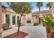 Serene courtyard with tiled flooring, a cozy fireplace, and an arched doorway for seamless indoor-outdoor living at 11527 Morning Grove Dr, Las Vegas, NV 89135