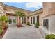 Picturesque courtyard featuring stone flooring, a charming fireplace, and access to multiple entryways at 11527 Morning Grove Dr, Las Vegas, NV 89135