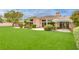 Single-story home with lush artificial turf, desert landscaping, and a stone facade at 11527 Morning Grove Dr, Las Vegas, NV 89135