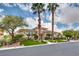 Well-maintained front yard featuring a lush lawn, mature trees, and manicured shrubs framing this beautiful home at 11527 Morning Grove Dr, Las Vegas, NV 89135