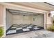Well-lit garage featuring black-and-white checkered flooring with a door to the side at 11527 Morning Grove Dr, Las Vegas, NV 89135