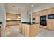 Gourmet kitchen with central island, wood cabinets, and modern appliances at 11527 Morning Grove Dr, Las Vegas, NV 89135