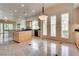 Open kitchen with a center island, stone tile floors, and french doors leading to the backyard at 11527 Morning Grove Dr, Las Vegas, NV 89135