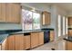 Bright kitchen with wood cabinets, granite countertops, and garden view at 11527 Morning Grove Dr, Las Vegas, NV 89135