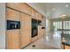 Gourmet kitchen with built-in appliances, wood cabinets, and breakfast bar at 11527 Morning Grove Dr, Las Vegas, NV 89135