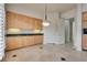 Bright kitchen featuring beautiful custom wood cabinetry, granite countertops and stone floors at 11527 Morning Grove Dr, Las Vegas, NV 89135
