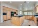 Gourmet kitchen featuring a central island, wood cabinets, and built-in appliances at 11527 Morning Grove Dr, Las Vegas, NV 89135