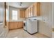 Spacious laundry room offers a sink, cabinets, and modern washer and dryer units at 11527 Morning Grove Dr, Las Vegas, NV 89135