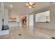 Open-concept living room with fireplace flows into a spacious kitchen area at 11527 Morning Grove Dr, Las Vegas, NV 89135