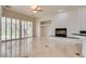 Spacious living room features a fireplace, ceiling fan, and sliding glass doors at 11527 Morning Grove Dr, Las Vegas, NV 89135