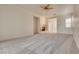Spacious living room with neutral carpet, a ceiling fan, and a cozy fireplace at 11527 Morning Grove Dr, Las Vegas, NV 89135