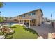 Spacious backyard featuring a pool, covered patio, and well-manicured artificial turf at 1191 Starstone Ct, Henderson, NV 89014