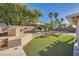 Beautiful backyard with a built-in grill, artificial turf, and a pool area, ideal for outdoor living at 1191 Starstone Ct, Henderson, NV 89014