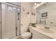 Clean bathroom featuring a glass-door shower, toilet, and a well-lit vanity area at 1191 Starstone Ct, Henderson, NV 89014