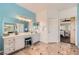 Bright bathroom with double vanity, modern lighting fixtures, and tile flooring at 1191 Starstone Ct, Henderson, NV 89014