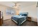 Comfortable bedroom with plush carpeting, window overlooking the neighborhood, and a ceiling fan at 1191 Starstone Ct, Henderson, NV 89014
