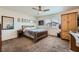 Inviting bedroom with a wood-frame bed, matching nightstand, and ample natural light at 1191 Starstone Ct, Henderson, NV 89014