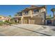 Attractive two-story home with a tiled roof, desert landscaping, and a spacious three-car garage with extended driveway at 1191 Starstone Ct, Henderson, NV 89014