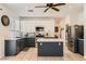 Modern kitchen featuring stainless steel appliances, kitchen island, and a neutral color palette at 1191 Starstone Ct, Henderson, NV 89014