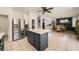 Modern kitchen featuring a center island, stainless steel appliances, and adjacent dining area at 1191 Starstone Ct, Henderson, NV 89014