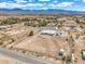 Expansive aerial view showcasing the property, surrounding area, and beautiful mountain backdrop at 1410 Tiptop Trl, Pahrump, NV 89048