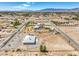 Expansive aerial view of a home showcasing its large lot, surrounding neighborhood, and scenic desert landscape at 1410 Tiptop Trl, Pahrump, NV 89048