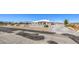 Exterior view of home with a circular driveway, desert landscape, and a mountain backdrop at 1410 Tiptop Trl, Pahrump, NV 89048