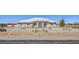 Desirable exterior displaying xeriscaped yard, a white tile roof, and mature trees at 1410 Tiptop Trl, Pahrump, NV 89048