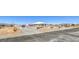 Gorgeous exterior featuring xeriscaped front yard, long driveway, and desert landscape at 1410 Tiptop Trl, Pahrump, NV 89048
