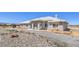 Desirable single-level home showcasing a classic design, xeriscaped landscaping, and a lengthy driveway for easy access at 1410 Tiptop Trl, Pahrump, NV 89048
