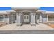 Inviting front entrance features a covered porch with decorative pillars and a double door entry for a grand arrival at 1410 Tiptop Trl, Pahrump, NV 89048