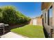 Backyard featuring artificial grass, block wall, and desert landscaping at 145 Austin Rose Ave, Henderson, NV 89002