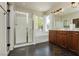 Spacious bathroom with a separate shower and tub, dark cabinets, and bright natural light at 145 Austin Rose Ave, Henderson, NV 89002