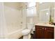 Bright bathroom featuring a shower over tub, vanity, toilet, and neutral color palette at 145 Austin Rose Ave, Henderson, NV 89002