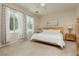 Light-filled bedroom with large windows, soft carpet, and neutral decor at 145 Austin Rose Ave, Henderson, NV 89002