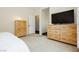 Cozy bedroom featuring light wood dressers and soft carpeting at 145 Austin Rose Ave, Henderson, NV 89002