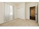 Neutral bedroom with a sliding closet and an open doorway at 145 Austin Rose Ave, Henderson, NV 89002