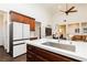 Open kitchen features modern stainless-steel appliances, white countertop island, and dark wood cabinets at 145 Austin Rose Ave, Henderson, NV 89002