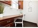 Bright laundry room featuring custom cabinets, desk area, and charming decor at 145 Austin Rose Ave, Henderson, NV 89002