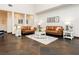 Cozy living room features dark tile flooring, light walls, and plenty of comfortable seating at 145 Austin Rose Ave, Henderson, NV 89002