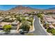 Neighborhood aerial view showcasing lush greenery, scenic streets, desert landscaping and mountain views at 145 Austin Rose Ave, Henderson, NV 89002