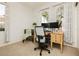 Comfortable home office with bright natural light, modern desk, and neutral carpeting at 145 Austin Rose Ave, Henderson, NV 89002