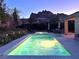 Inviting backyard pool and spa surrounded by ambient lighting and mountain views at 145 Austin Rose Ave, Henderson, NV 89002