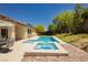Backyard featuring a swimming pool, hot tub, patio, and lush landscaping at 145 Austin Rose Ave, Henderson, NV 89002