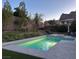 Beautiful backyard pool with a spa, landscaped yard, and mountain views at 145 Austin Rose Ave, Henderson, NV 89002