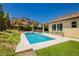 Backyard featuring a swimming pool, desert landscaping and rock formations in the background at 145 Austin Rose Ave, Henderson, NV 89002